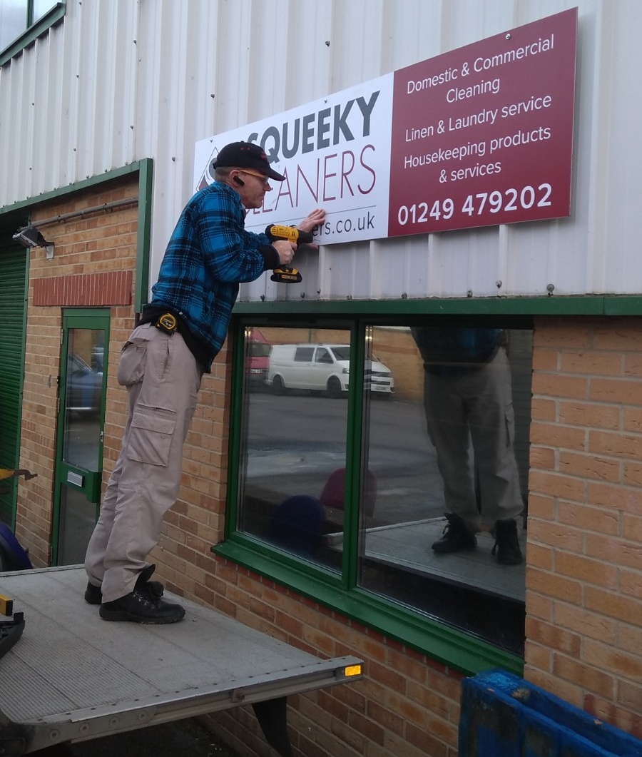 squeeky sign being put up